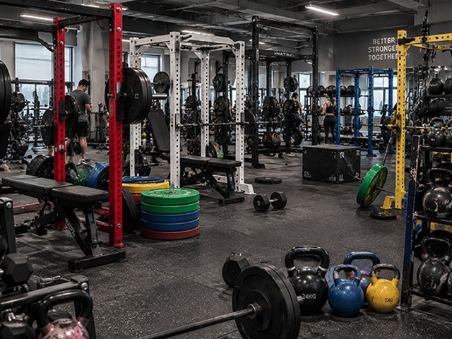 Mixed commercial gym zones with racks and kettlebells